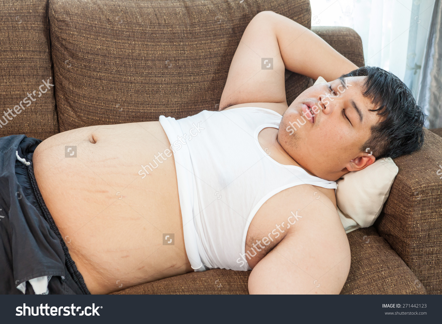stock-photo-fat-asian-man-sleeping-on-the-couch-271442123.jpg